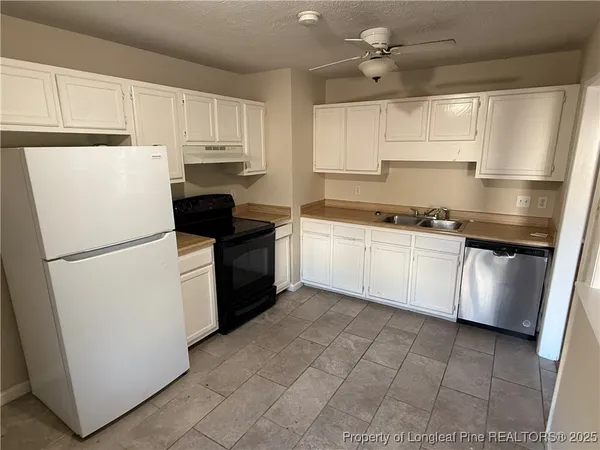 a kitchen with a white cabinets and white appliances