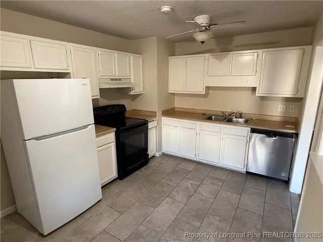 a kitchen with a white cabinets and white appliances
