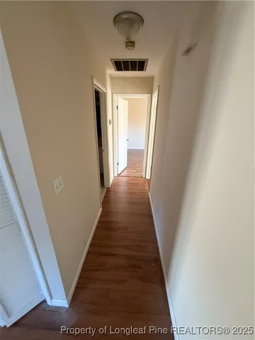 a view of a hallway to a bedroom