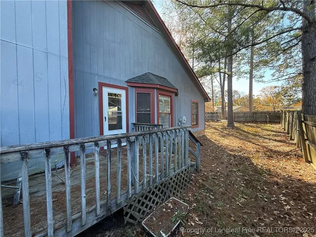 a view of a house with wooden fence