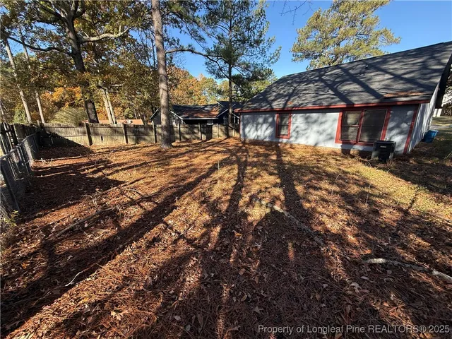 a view of a yard with plants and trees