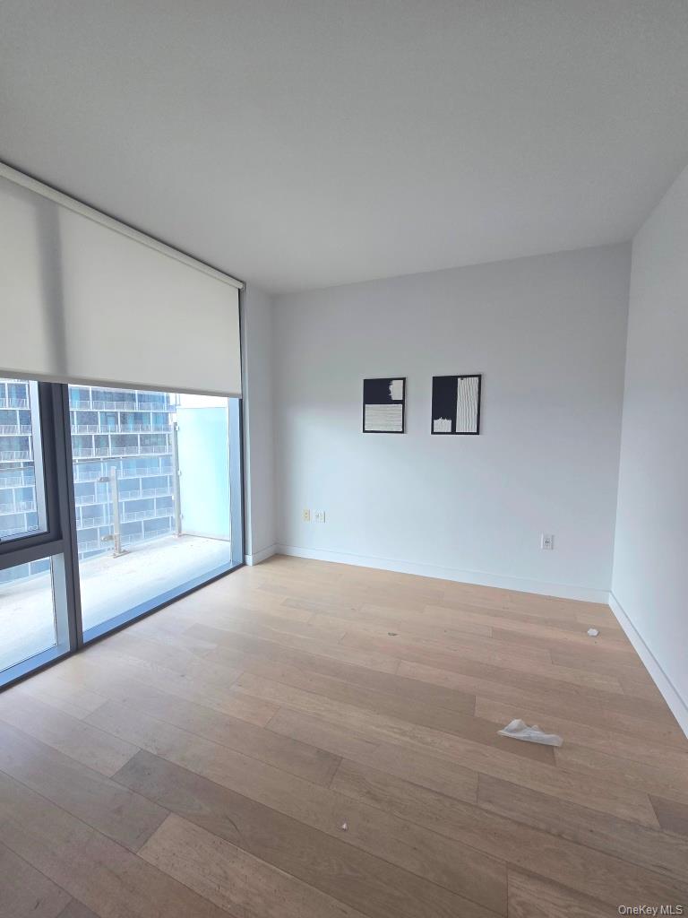 131-01 40 Road, Unit 11P Queens, NY 11354 - Photo 13 of 17 a view of an empty room with a window