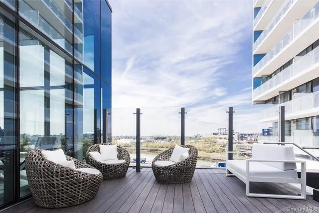 a balcony with furniture and view of city view