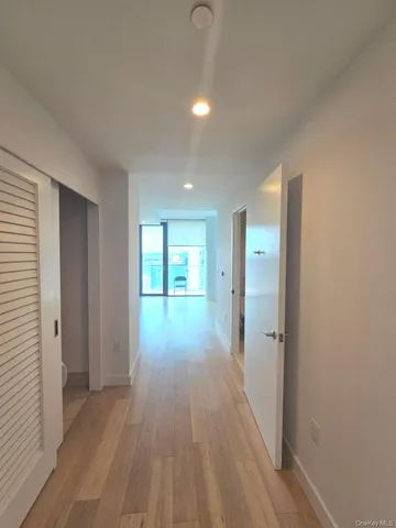 a view of hallway with wooden floor