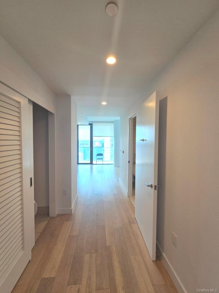 131-01 40 Road, Unit 11P Queens, NY 11354 - Photo 9 of 17 a view of hallway with wooden floor