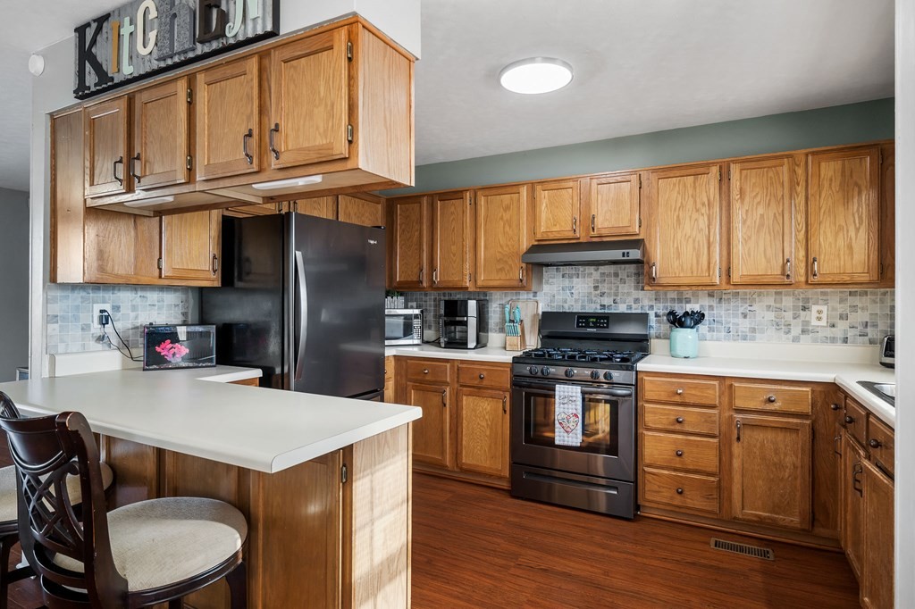 1656 Parker Road Sparta, TN 38583 - Photo 13 of 32 a kitchen with stainless steel appliances a sink a stove a refrigerator cabinets and a center island
