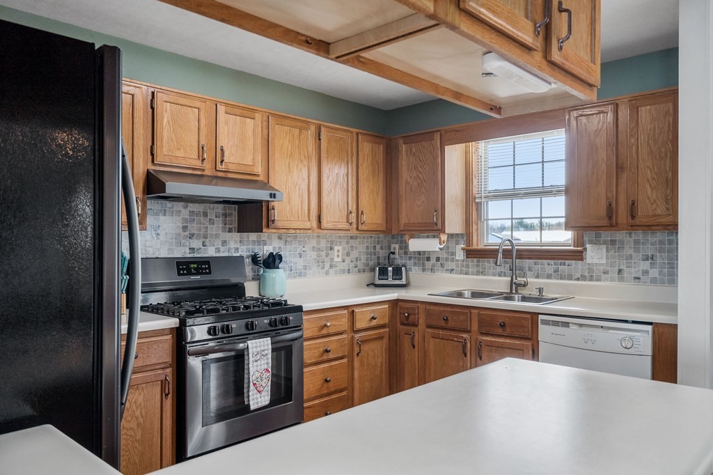 1656 Parker Road Sparta, TN 38583 - Photo 14 of 32 a kitchen with stainless steel appliances granite countertop a sink a stove a refrigerator cabinets and a window