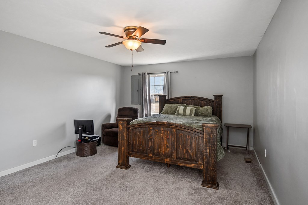 1656 Parker Road Sparta, TN 38583 - Photo 26 of 32 a bedroom with a bed and a chandelier