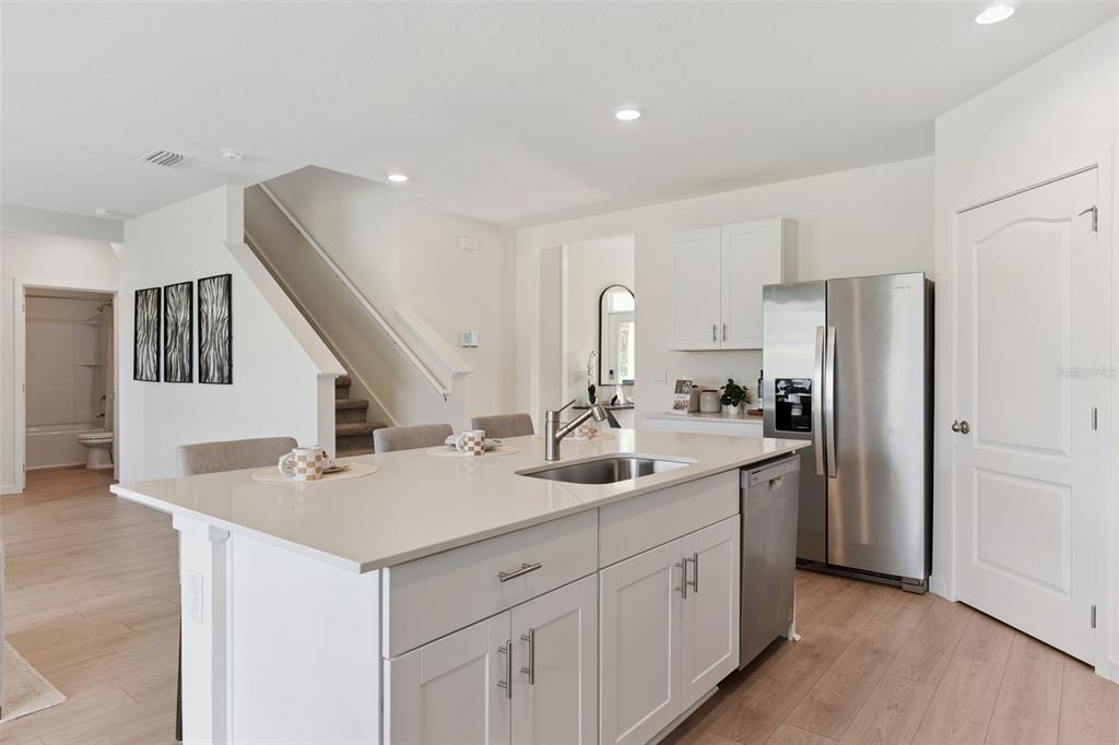 2857 House Finch Road St. Cloud, FL 34773 - Photo 16 of 70 a kitchen with a sink and refrigerator