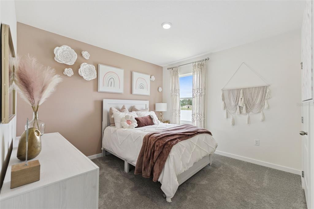 2857 House Finch Road St. Cloud, FL 34773 - Photo 23 of 70 a bedroom with a bed and a sink