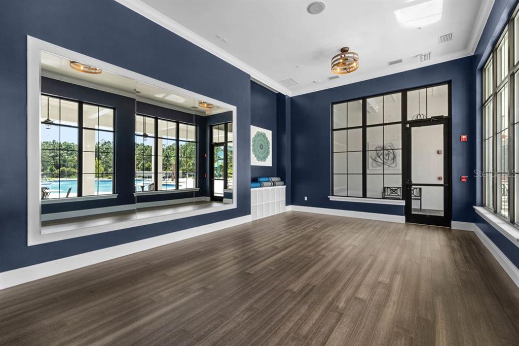 2857 House Finch Road St. Cloud, FL 34773 - Photo 38 of 70 a view of an empty room with wooden floor and a window