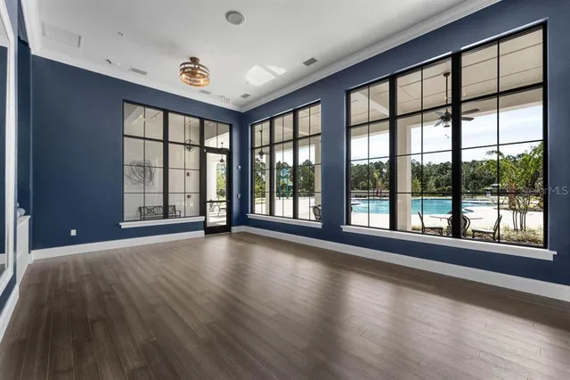 a living room with furniture and floor to ceiling windows