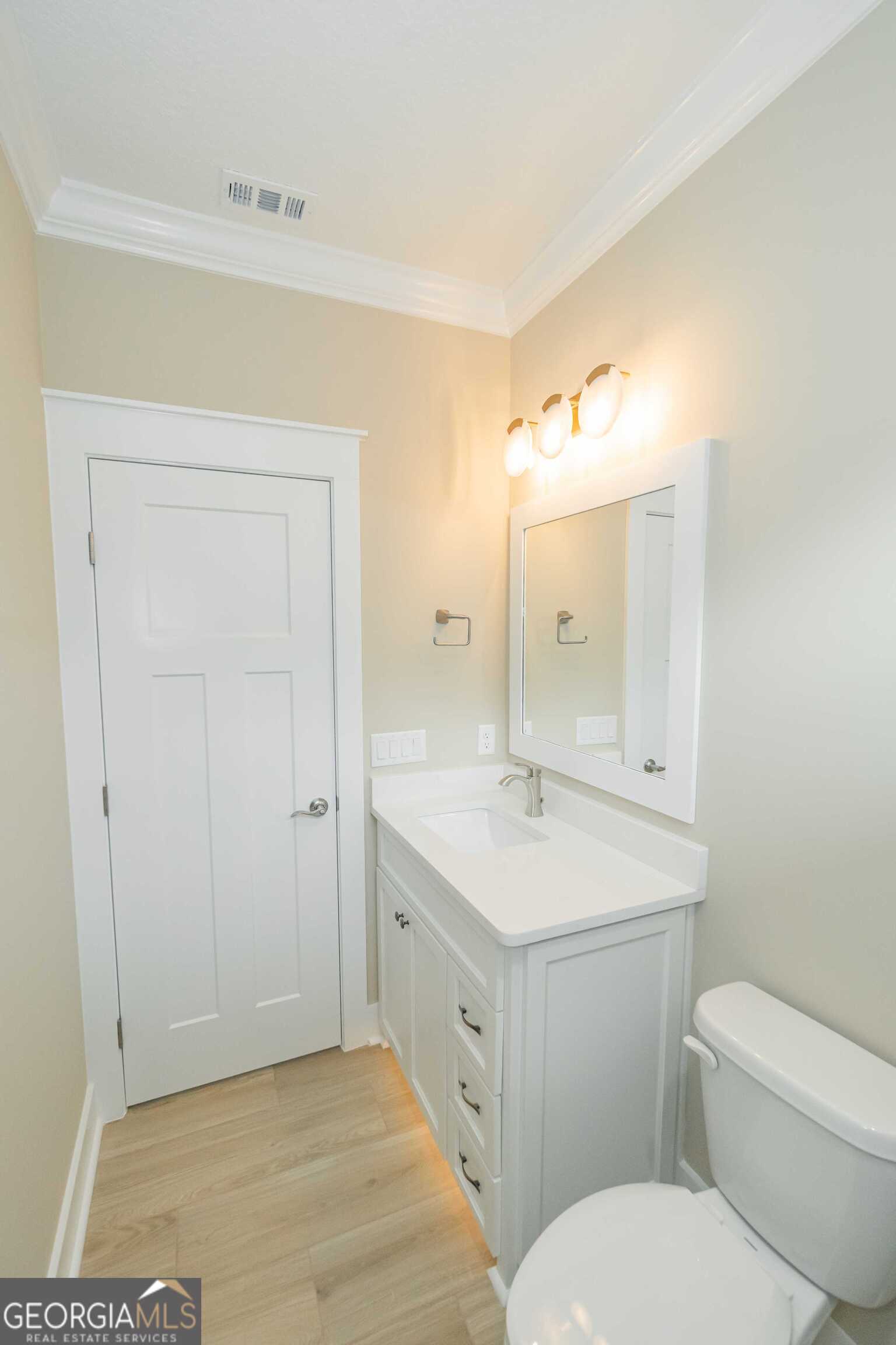 201 Riley Hunter Drive Kingsland, GA 31548 - Photo 60 of 79 a spacious bathroom with a toilet a sink a mirror and a shower
