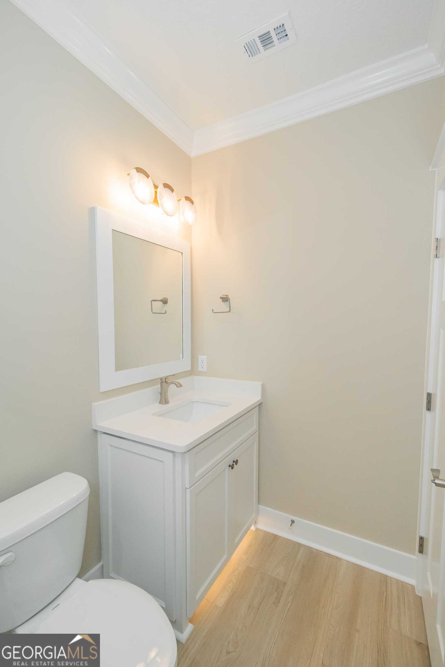 201 Riley Hunter Drive Kingsland, GA 31548 - Photo 66 of 79 a bathroom with a granite countertop sink a toilet and a mirror