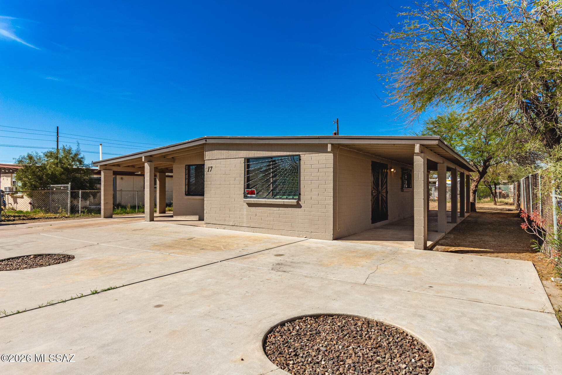 17 East Los Reales Road Tucson, AZ 85756 - Photo 1 of 27 a front view of a house with a garden
