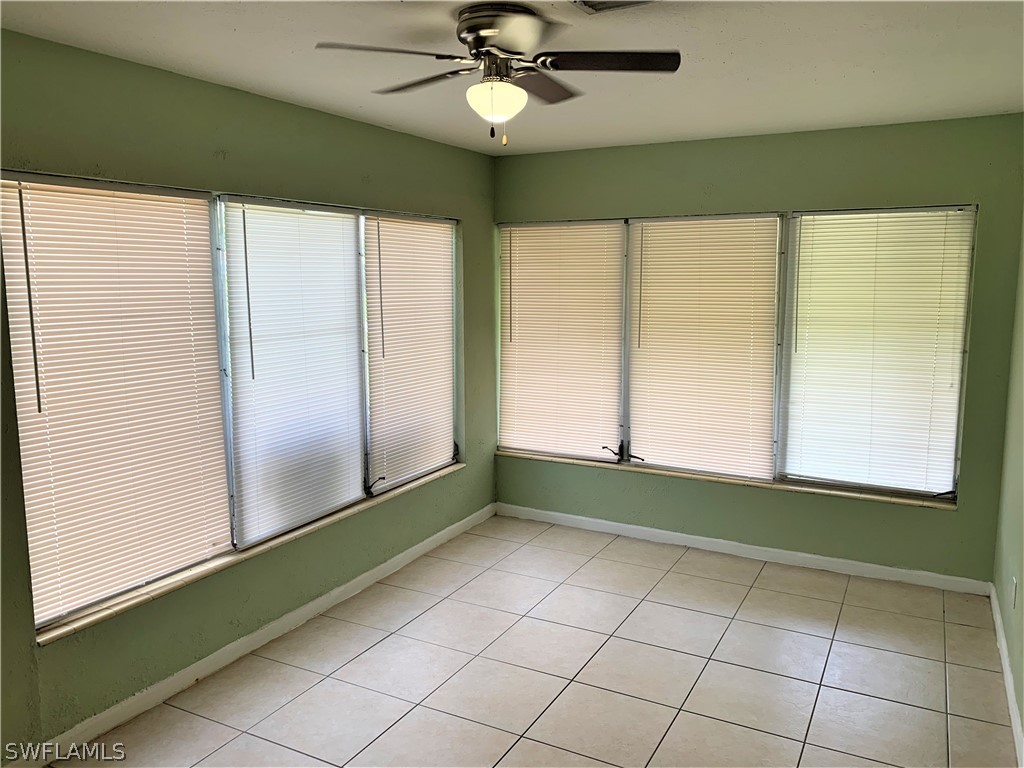 301 East Penn Road Lehigh Acres, FL 33936 - Photo 17 of 25 a view of an empty room with window and chandelier fan