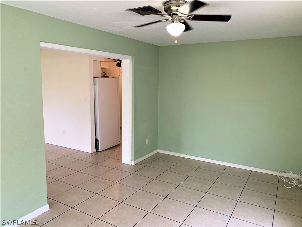 301 East Penn Road Lehigh Acres, FL 33936 - Photo 18 of 25 en empty room with windows and fan