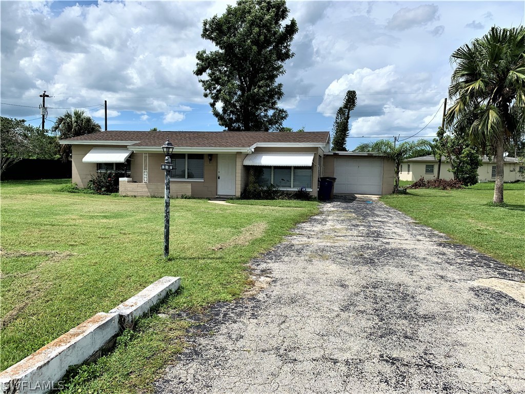 301 East Penn Road Lehigh Acres, FL 33936 - Photo 25 of 25 a front view of a house with garden