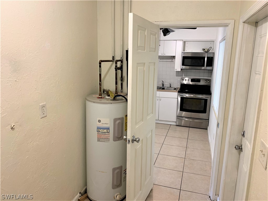 301 East Penn Road Lehigh Acres, FL 33936 - Photo 4 of 25 a kitchen with a refrigerator and a stove