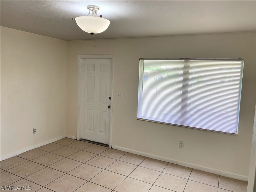 301 East Penn Road Lehigh Acres, FL 33936 - Photo 5 of 25 an empty room with a window