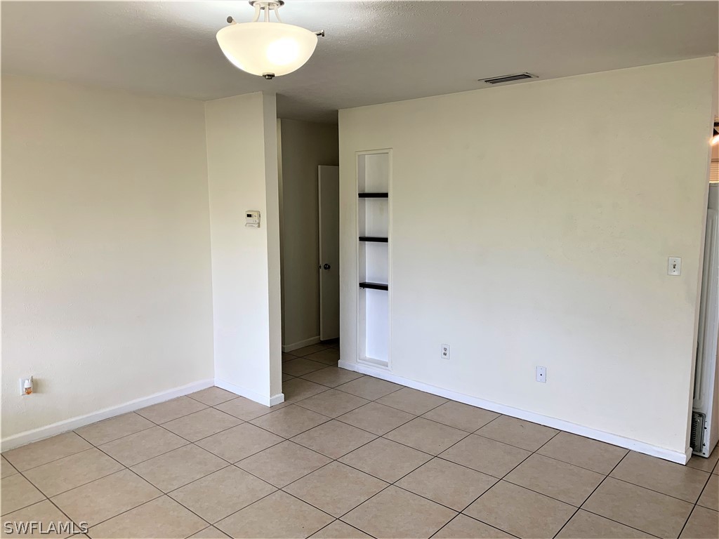 301 East Penn Road Lehigh Acres, FL 33936 - Photo 6 of 25 a view of an empty room and chandelier fan