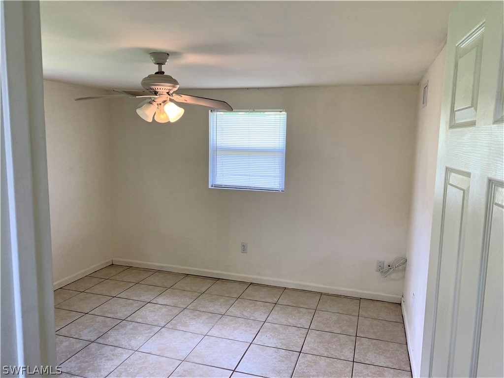 301 East Penn Road Lehigh Acres, FL 33936 - Photo 7 of 25 an empty room with windows and fan