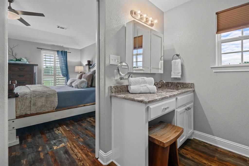 175 Porter Road Bartonville, TX 76226 - Photo 20 of 40 a en suite bathroom with a granite countertop sink and a mirror