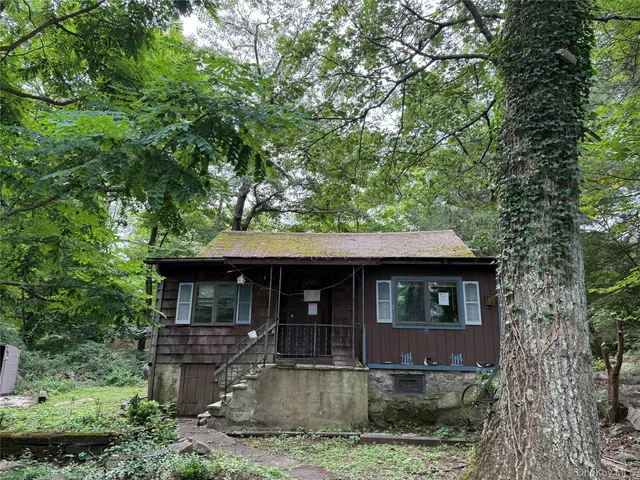 a front view of a house with yard porch and green space