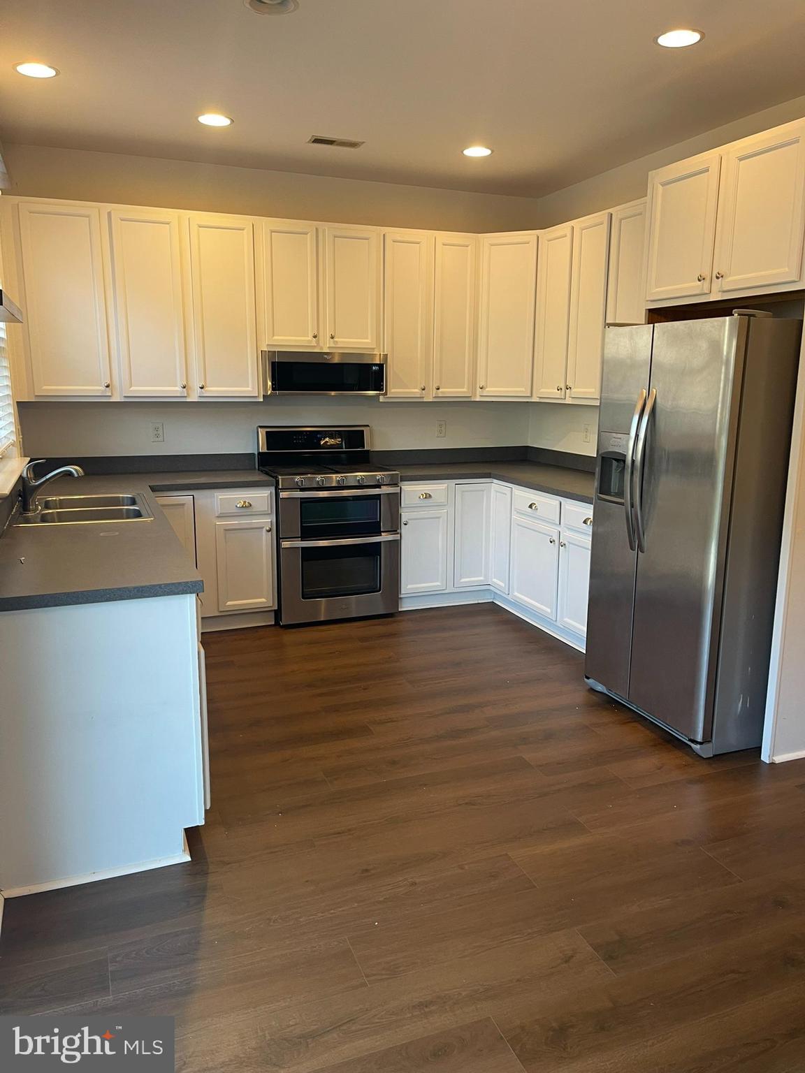 310 Norwalk Way Middletown, DE 19709 - Photo 12 of 37 a kitchen with granite countertop a refrigerator and a stove top oven