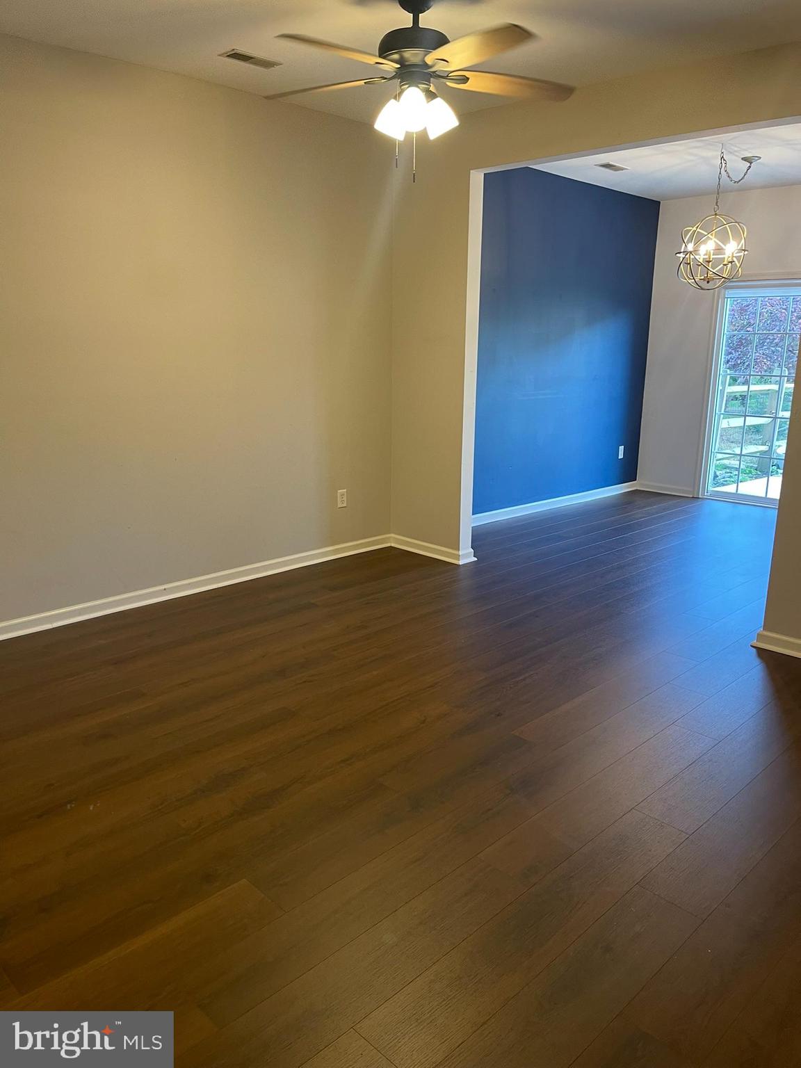 310 Norwalk Way Middletown, DE 19709 - Photo 9 of 37 a view of a room with wooden floor and a ceiling fan