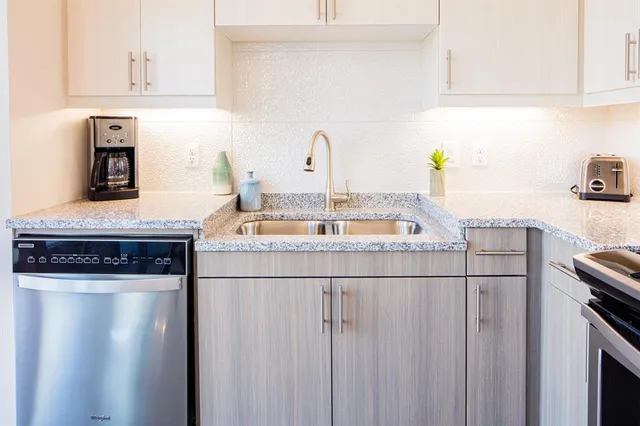 a kitchen with a sink cabinets and appliances