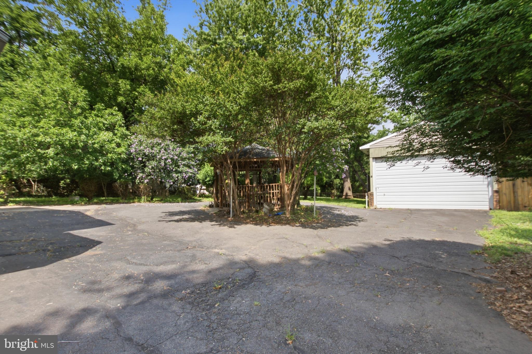 511 Malcolm Road Northwest Vienna, VA 22180 - Photo 6 of 16 a view of a house with a tree and a yard