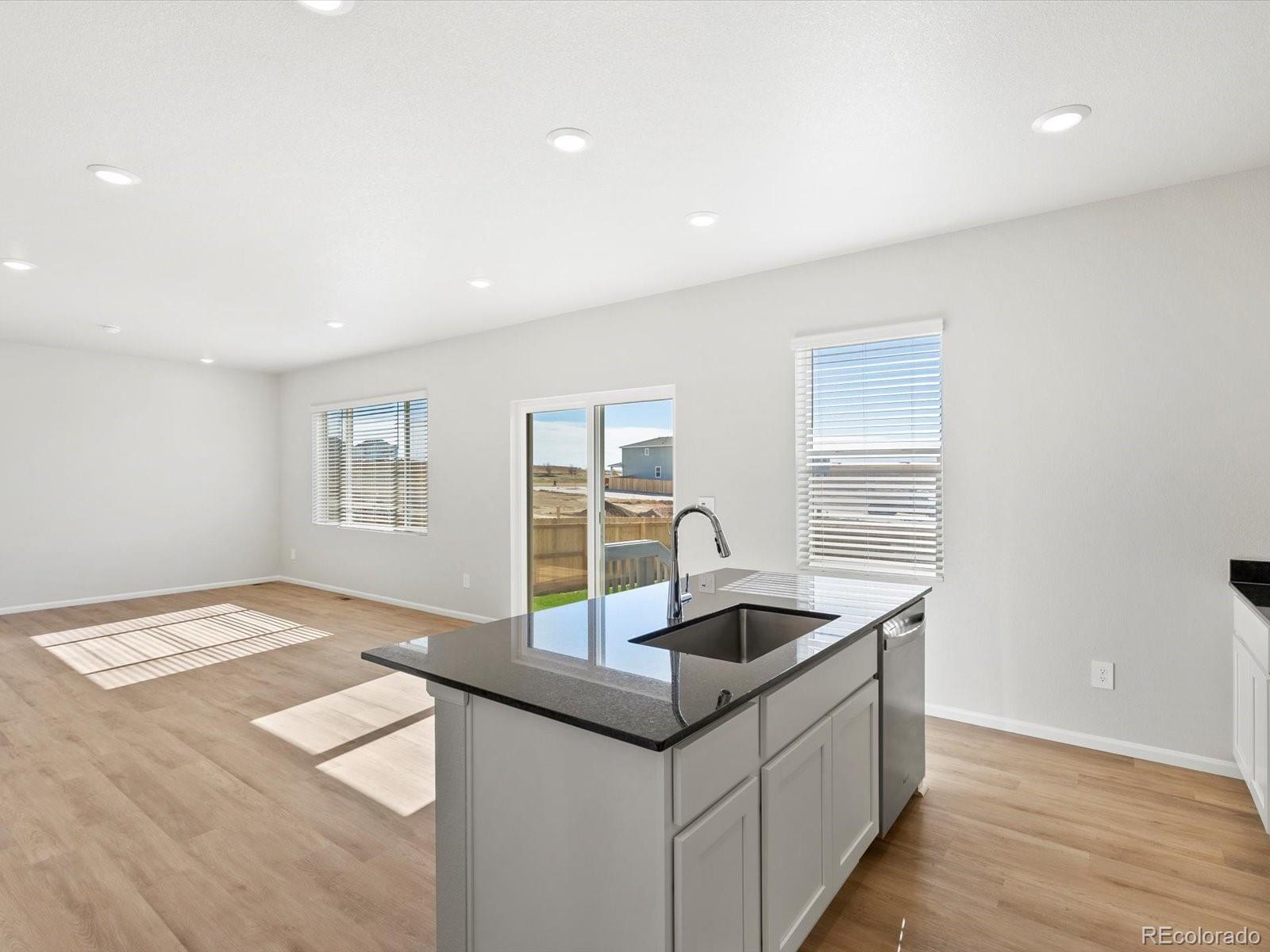 7305 West 27th St Road Greeley, CO 80634 - Photo 13 of 29 a kitchen with stainless steel appliances granite countertop a sink and a stove