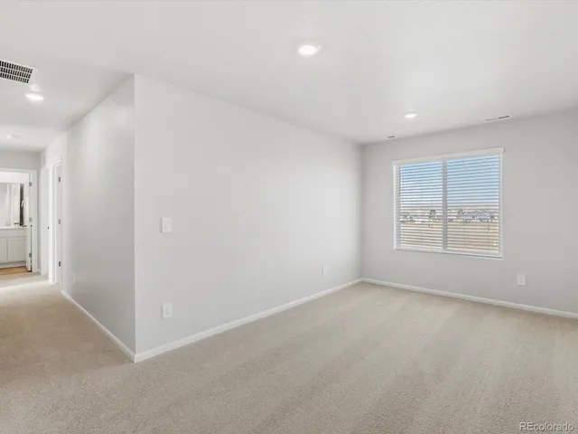 an empty room with windows and closet