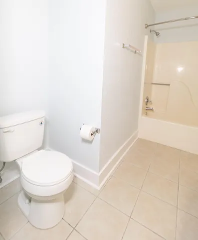 a white toilet sitting next to a bathroom sink