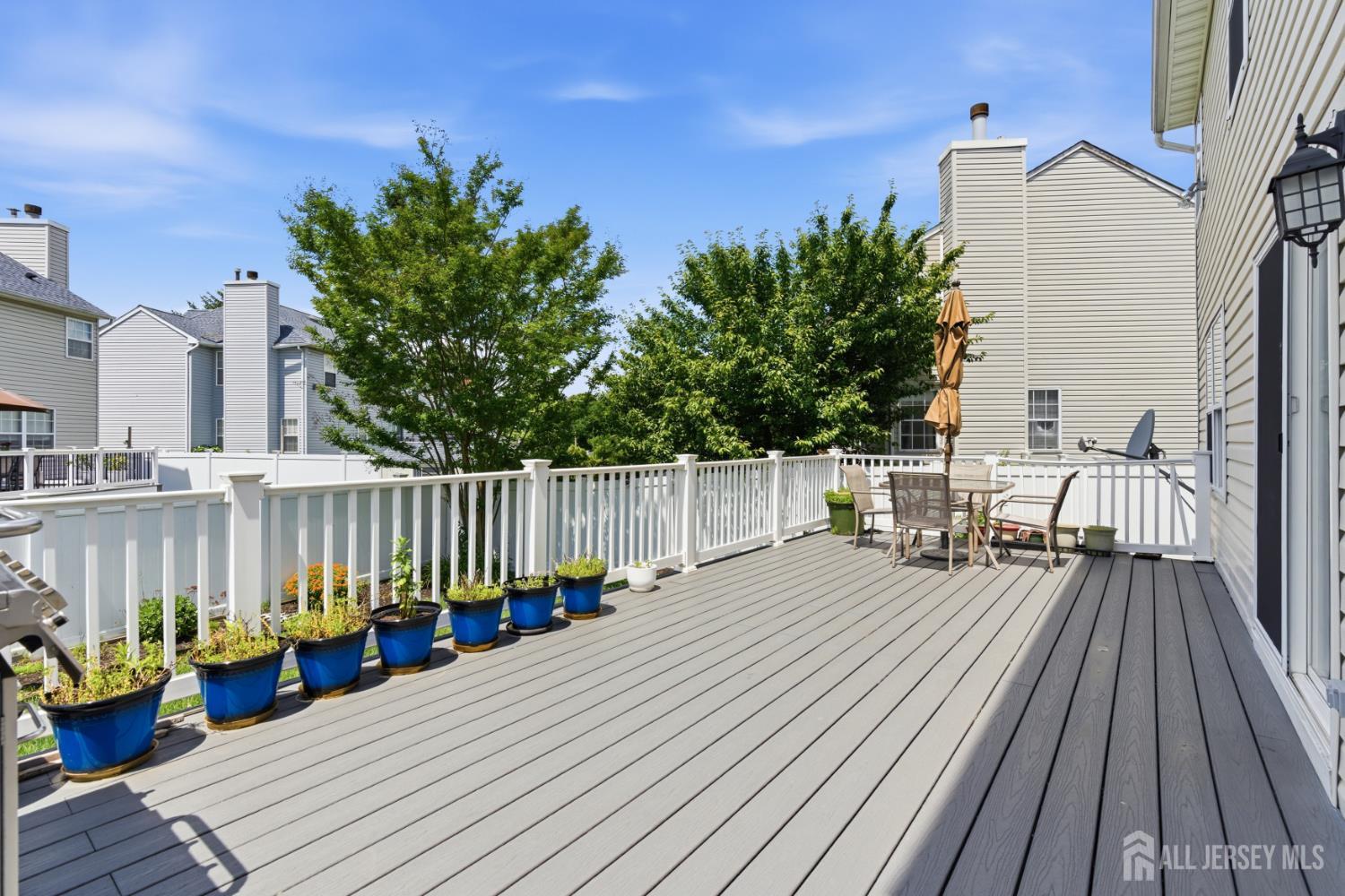 26 Alexis Lane Edison, NJ 08820 - Photo 37 of 39 a balcony with wooden floor table and chairs