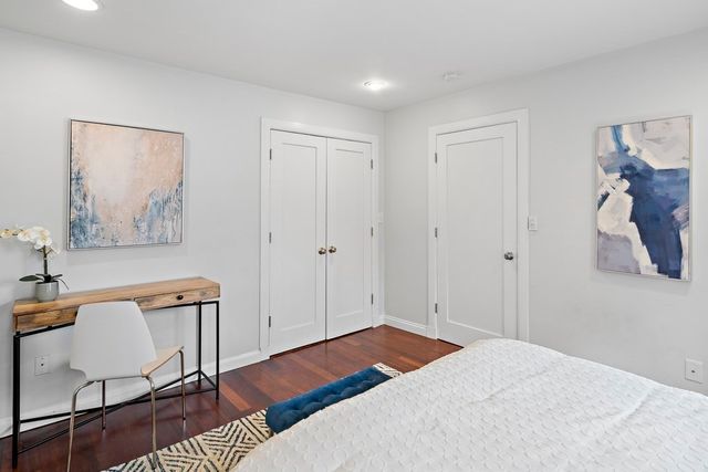 a bedroom with a bed and a lamp on table