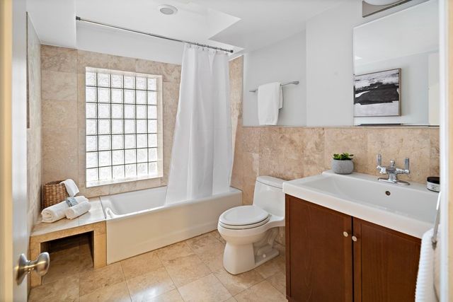 a spacious bathroom with a bathtub sink and toilet