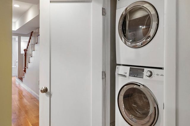 a view of a hallway with washer and dryer