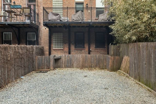 a view of a house with a wooden fence