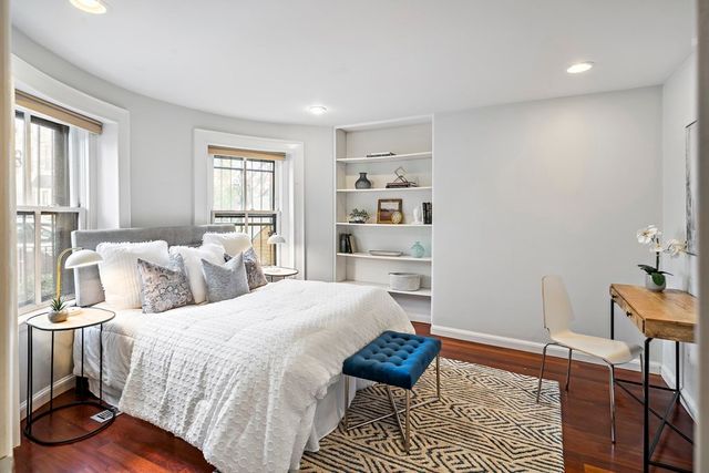 a bedroom with a bed and a table with chair