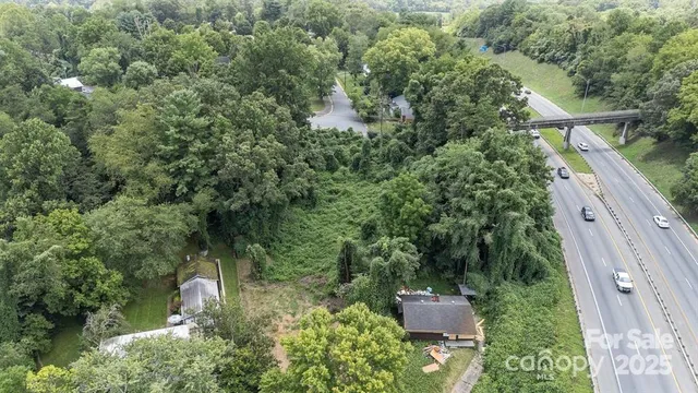 an aerial view of a house with a yard and lake view