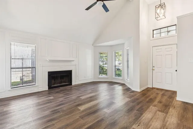 wooden floor fireplace and natural light in room