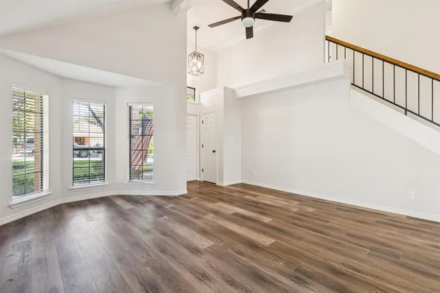 a view of a livingroom with wooden floor and a window