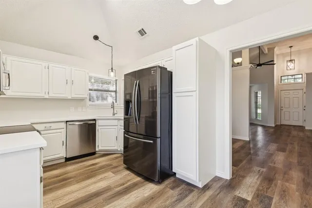 a kitchen with a refrigerator and a sink
