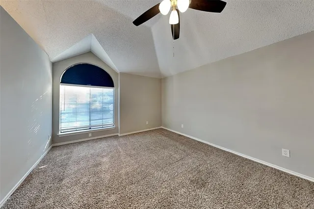 an empty room with a empty space and a ceiling fan