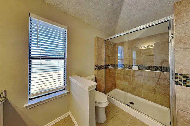 a bathroom with a shower and a toilet