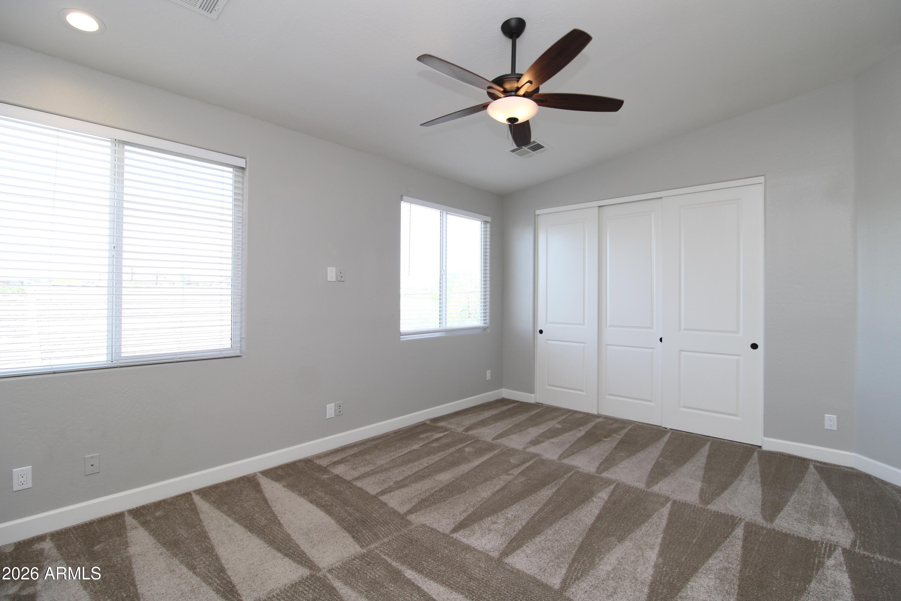 1024 East Curry Road, Unit 1A Tempe, AZ 85288 - Photo 11 of 23 a view of a big room with windows and chandelier fan