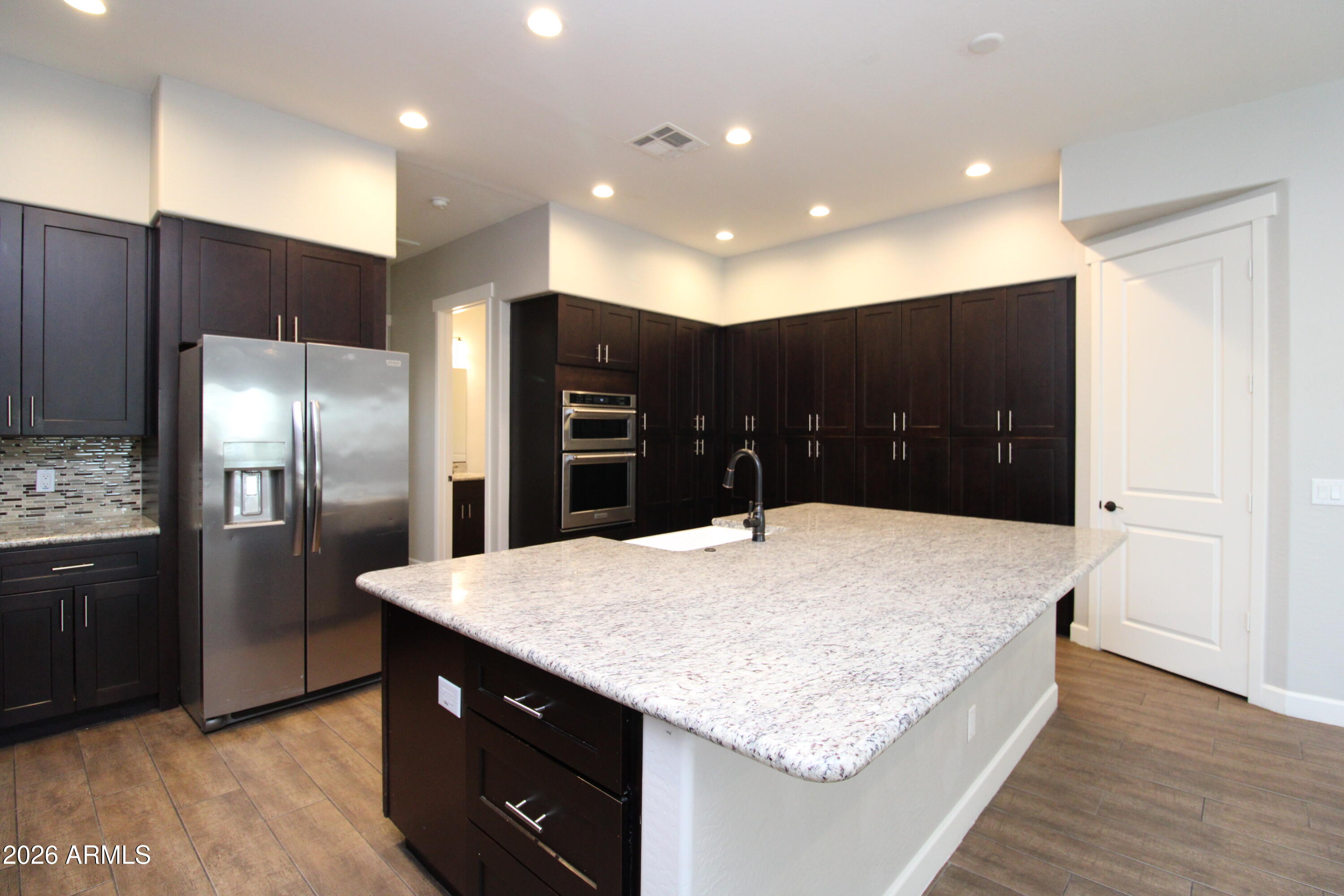 1024 East Curry Road, Unit 1A Tempe, AZ 85288 - Photo 4 of 23 a kitchen with stainless steel appliances granite countertop a refrigerator and a sink