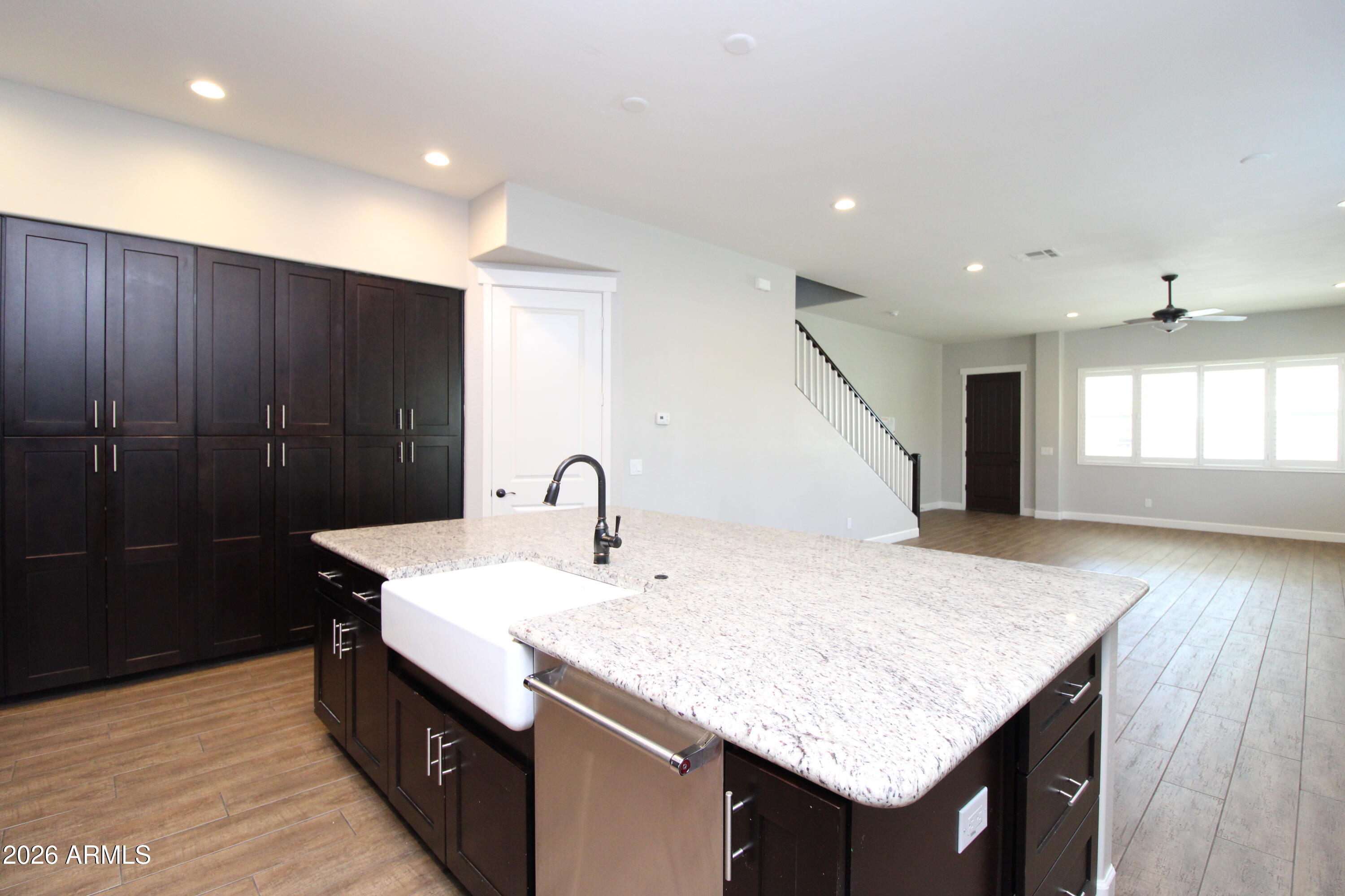 1024 East Curry Road, Unit 1A Tempe, AZ 85288 - Photo 5 of 23 a kitchen with sink cabinets and wooden floor
